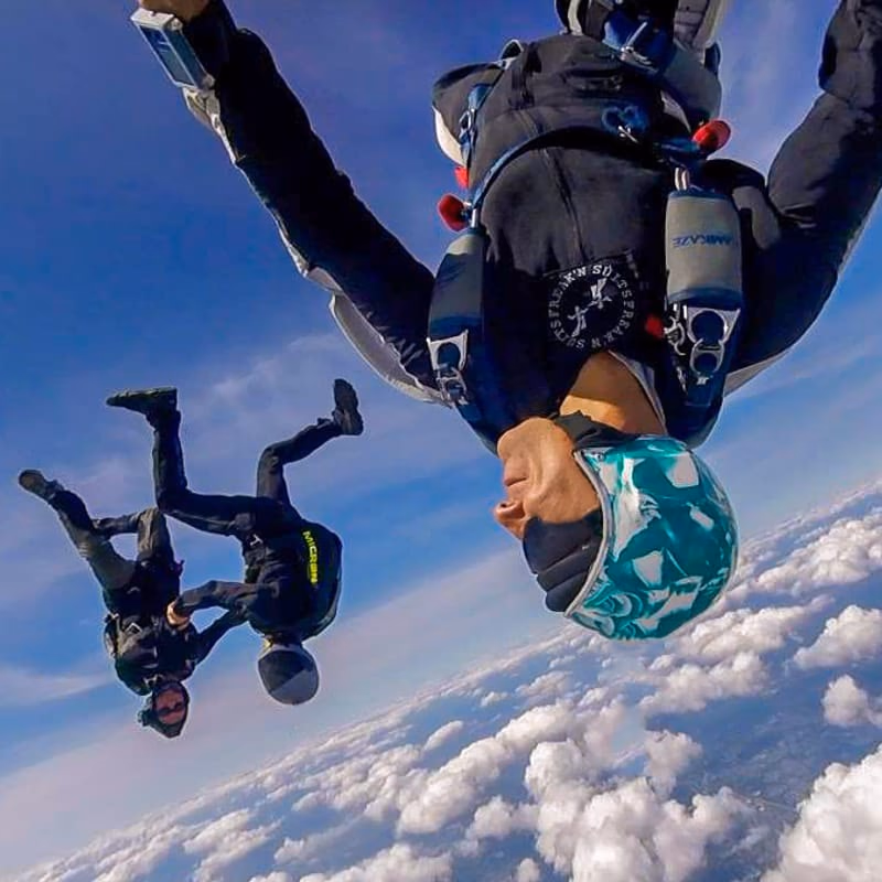 Dr. Hazaveh skydiving head-down above the clouds